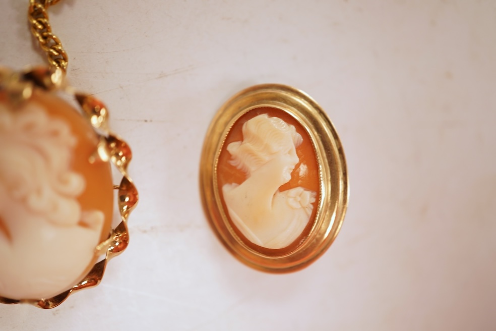 A collection of five cameo brooches, each of oval outline, set with a carved shell cameo, variously depicting three women in profile, a seated lady doing needlework, and a pastoral scene of a shepherd, longest 6.8cm, thr